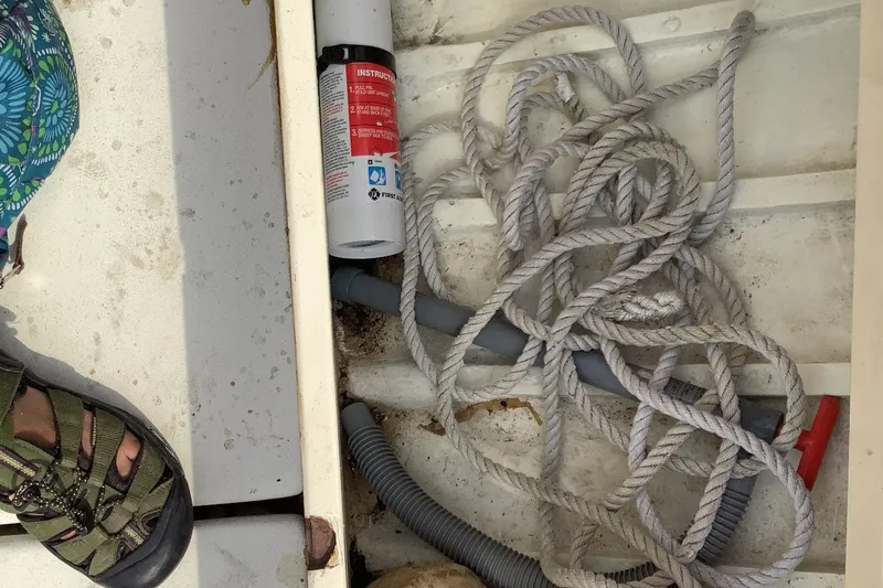 Slide: The Image of Coiled rope and fire extinguisher in a 1975 Halberg Rassey P-28 boat compartment. - 21