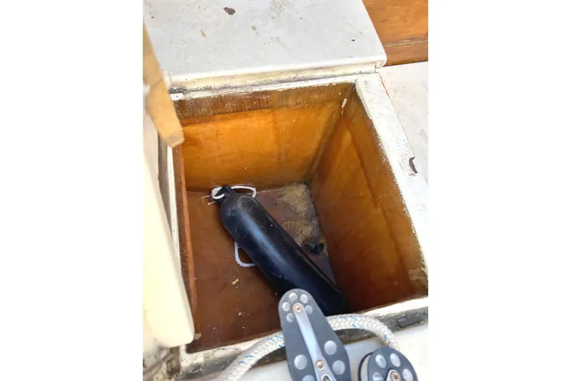 Slide: The Image of Open storage compartment on 1975 Halberg Rassey P-28 boat with black fender inside. - 45