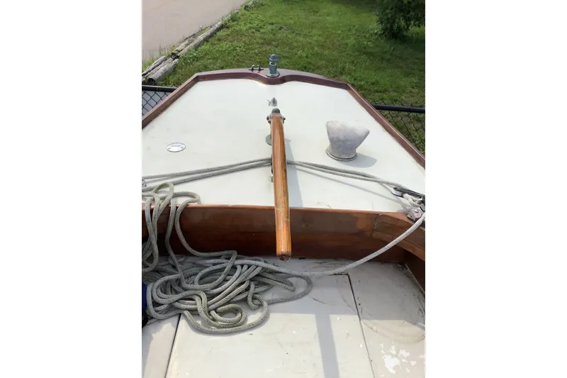 Slide: The Image of 1975 Halberg Rassey P-28 sailboat deck with ropes and wooden tiller. - 13