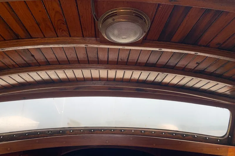 Slide: The Image of Wooden interior ceiling of 1975 Halberg Rassey P-28 boat with vintage light fixture. - 34