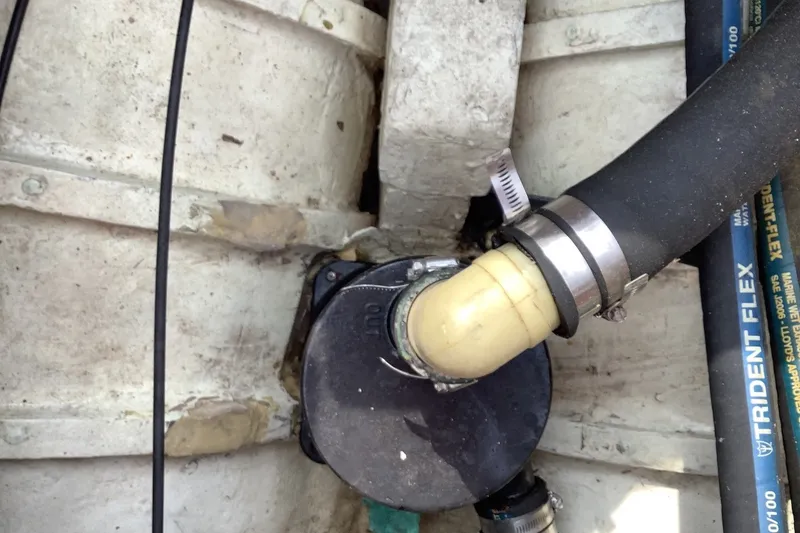 Slide: The Image of Boat plumbing system in a 1975 Halberg Rassey P-28, featuring hoses and connectors. - 24