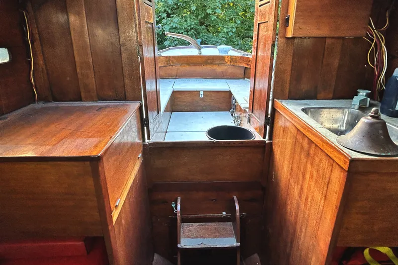 Slide: The Image of Interior of a 1975 Halberg Rassey P-28 sailboat with wooden cabinetry and sink. - 27