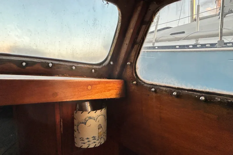 Slide: The Image of Interior view of a 1975 Halberg Rassey P-28 sailboat with wooden trim and nautical decor. - 42