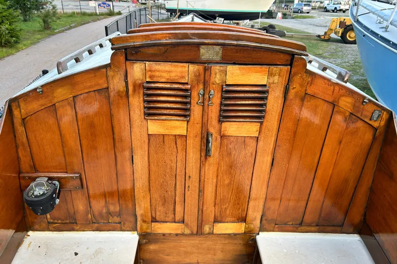 Slide: The Image of Wooden cockpit of a 1975 Halberg Rassey P-28 sailboat, featuring classic design elements. - 23