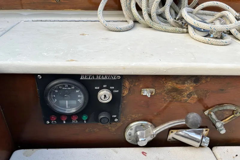 Slide: The Image of 1975 Halberg Rassey P-28 boat control panel with Beta Marine gauge and coiled rope. - 47