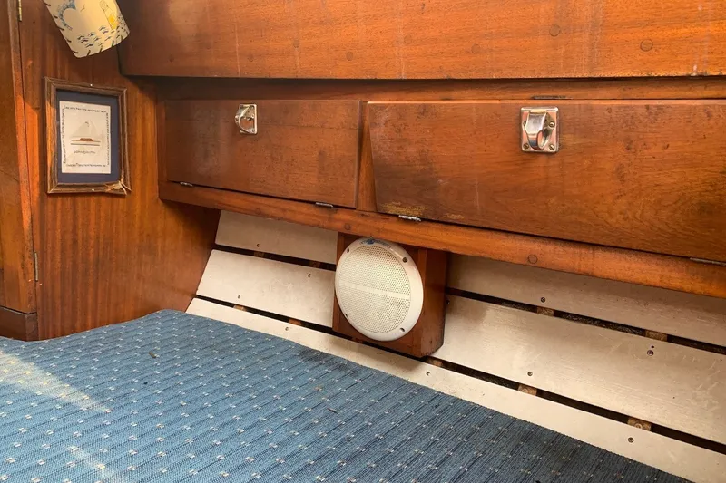 Slide: The Image of Interior of a 1975 Halberg Rassey P-28 sailboat with wooden cabinetry. - 29