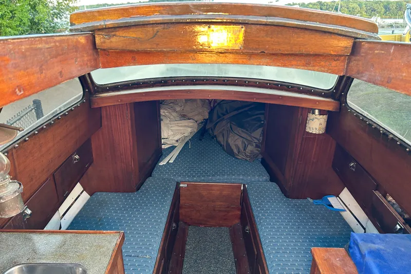 Slide: The Image of Interior of a 1975 Halberg Rassey P-28 sailboat with wooden finish and blue carpet. - 36
