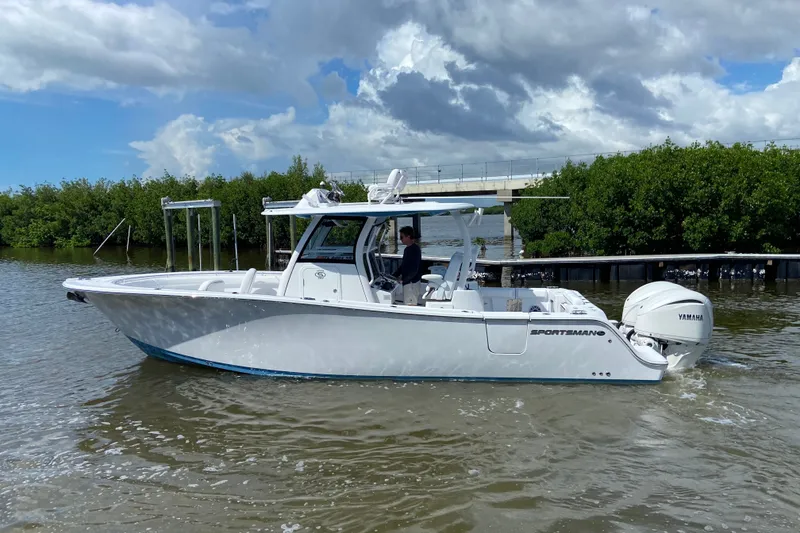 Slide: The Image of 2026 Sportsman Open 302 Center Console boat on water, featuring Yamaha engine. - 9