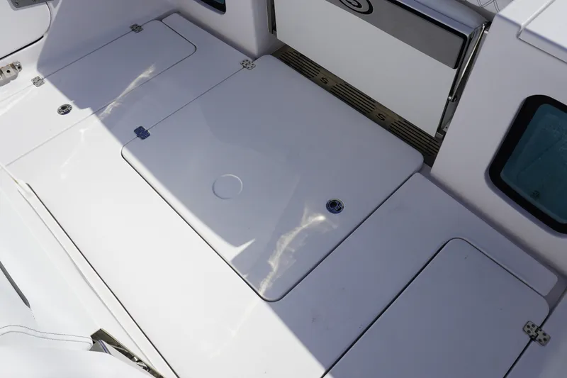 Slide: The Image of 2026 Sportsman Open 302 Center Console deck with storage compartments and sleek design. - 19