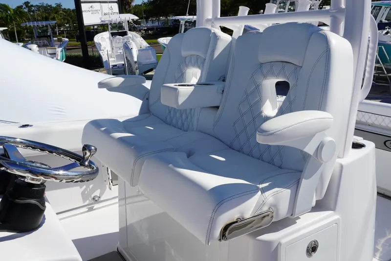 Slide: The Image of Luxurious seating on 2026 Sportsman Open 302 Center Console boat, featuring plush white upholstery. - 24