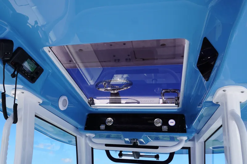 Slide: The Image of 2026 Sportsman Open 302 Center Console interior with blue ceiling and steering wheel view. - 25