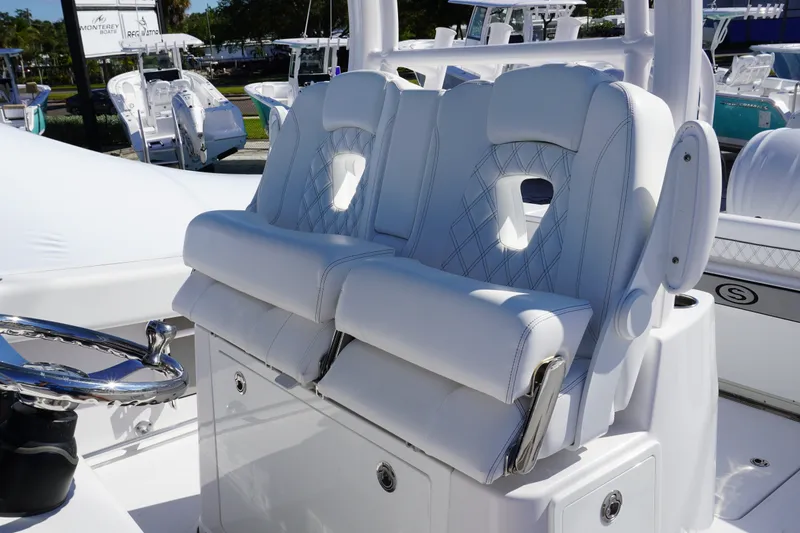 Slide: The Image of 2026 Sportsman Open 302 Center Console with luxurious white seating and steering wheel. - 23