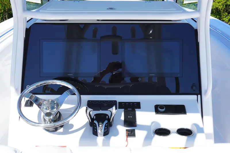 Slide: The Image of 2026 Sportsman Open 302 Center Console dashboard with dual screens and steering wheel. - 21