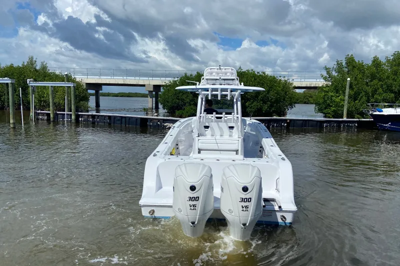 Slide: The Image of 2026 Sportsman Open 302 Center Console boat with dual engines on water. - 6