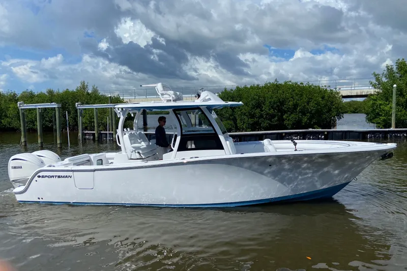Slide: The Image of 2026 Sportsman Open 302 Center Console boat on water, cloudy sky background. - 4