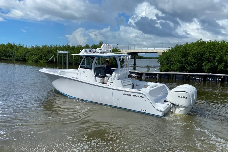 Slide: The Image of 2026 Sportsman Open 302 Center Console boat on water, featuring Yamaha engines. - 8