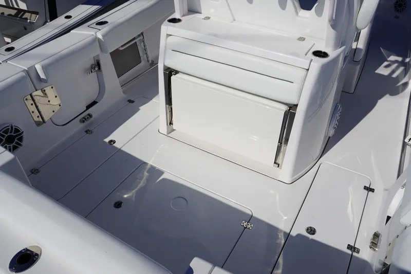Slide: The Image of 2026 Sportsman Open 302 Center Console boat interior with seating and storage compartments. - 13