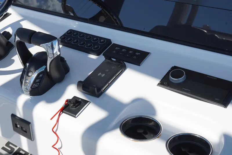 Slide: The Image of 2026 Sportsman Open 302 Center Console dashboard with controls and electronic devices. - 22
