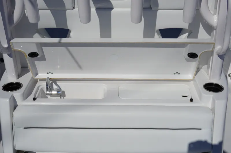 Slide: The Image of 2026 Sportsman Open 302 Center Console boat interior with storage compartment and seating. - 15