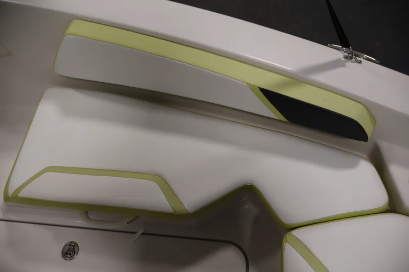 Slide: The Image of Interior seating of a 2016 Scarab 165 G boat with white and green upholstery. - 13