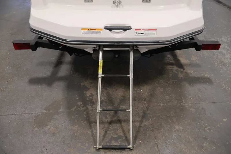 Slide: The Image of Rear view of a 2016 Scarab 165 G boat with a metal boarding ladder. - 30