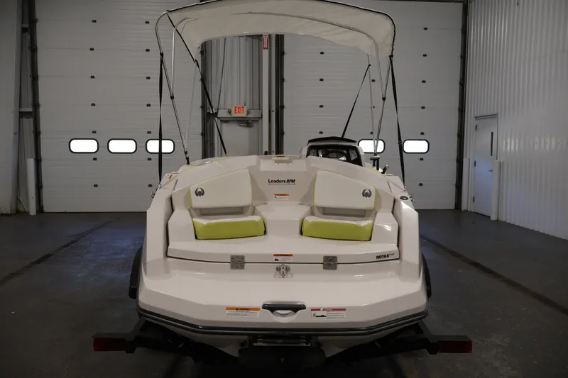 Slide: The Image of 2016 Scarab 165 G boat in a garage, rear view with canopy and seating. - 6