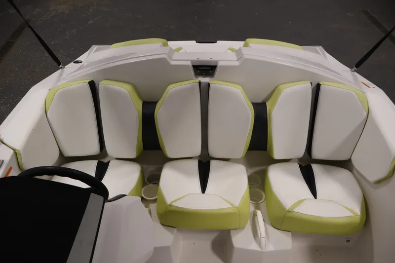 Slide: The Image of Interior seating of a 2016 Scarab 165 G boat with white and green upholstery. - 24