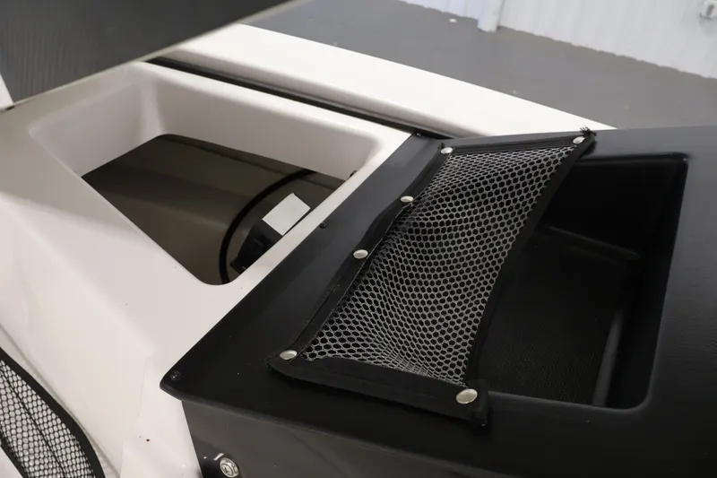Slide: The Image of 2016 Scarab 165 G boat interior storage compartment with mesh netting. - 35