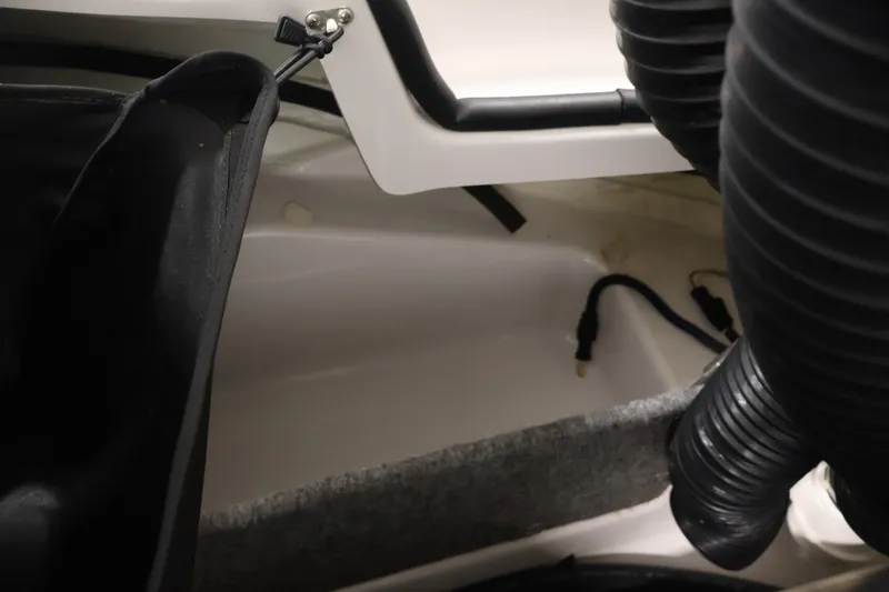 Slide: The Image of Interior view of a 2016 Scarab 165 G boat showing storage and wiring. - 27