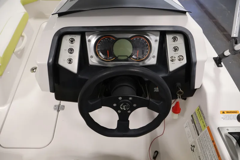 Slide: The Image of Dashboard of a 2016 Scarab 165 G boat with steering wheel and controls. - 18