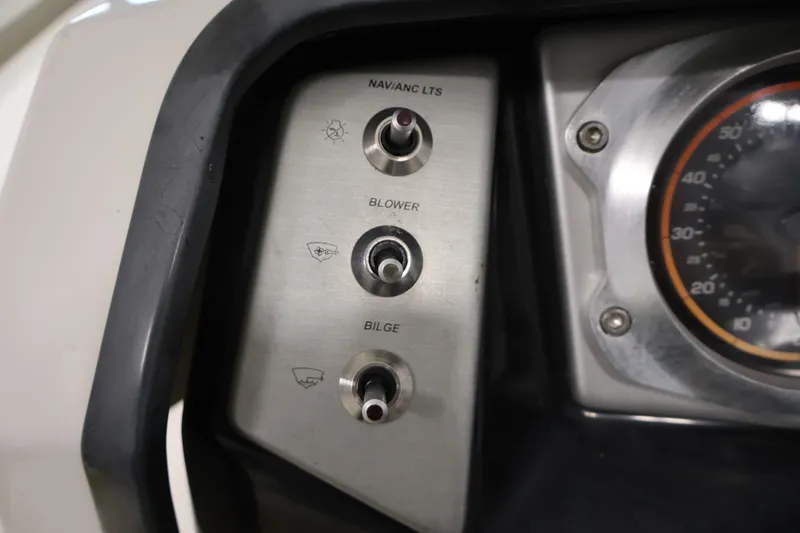 Slide: The Image of Control panel of a 2016 Scarab 165 G boat with switches and speedometer. - 21