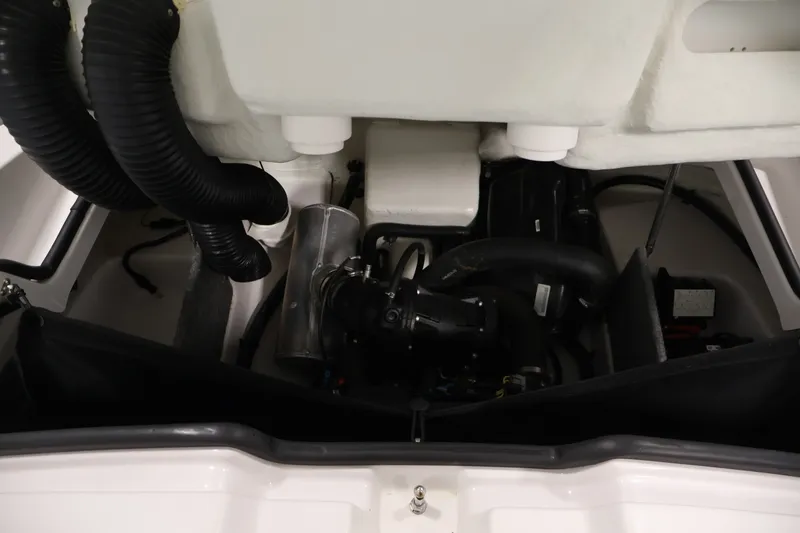 Slide: The Image of Engine compartment of a 2016 Scarab 165 G boat, showcasing hoses and components. - 25