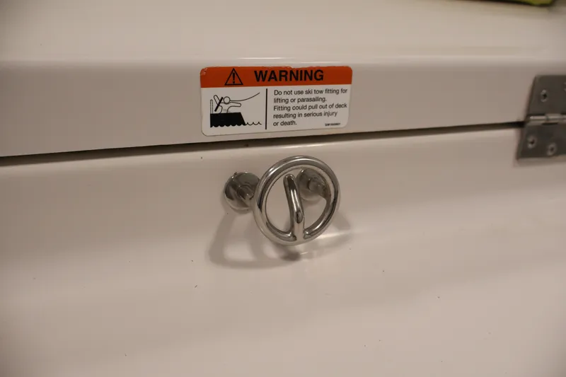 Slide: The Image of Warning label and ski tow fitting on 2016 Scarab 165 G boat deck. - 29