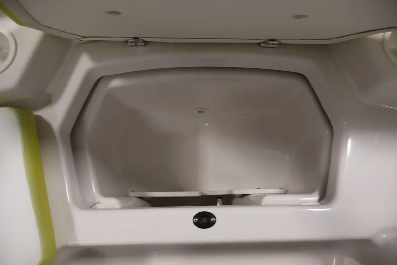 Slide: The Image of Storage compartment of a 2016 Scarab 165 G boat, featuring a spacious interior. - 12