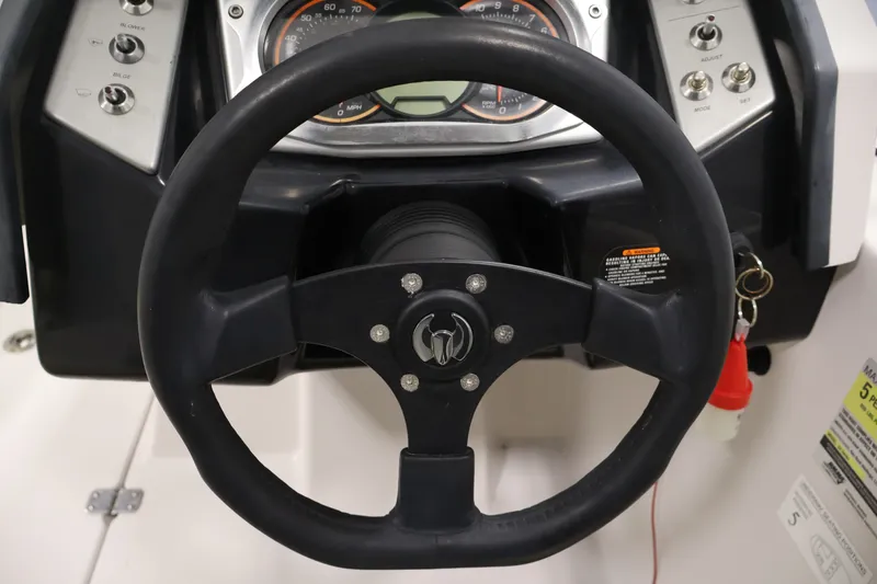 Slide: The Image of Steering wheel and dashboard of a 2016 Scarab 165 G boat. - 19