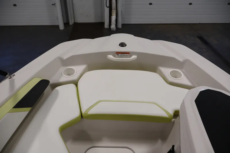 Slide: The Image of Interior view of a 2016 Scarab 165 G boat, featuring cushioned seating and cup holders. - 11