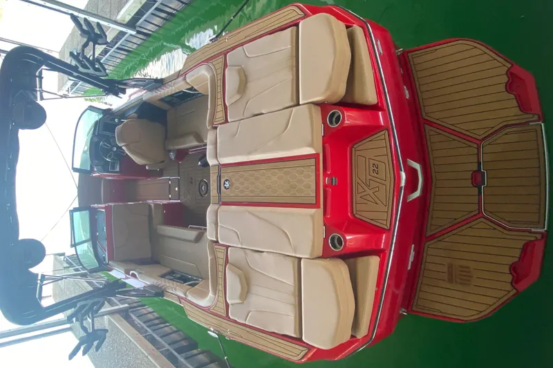 Slide: The Image of 2024 MasterCraft XT22 boat interior with tan seats and red accents. - 4