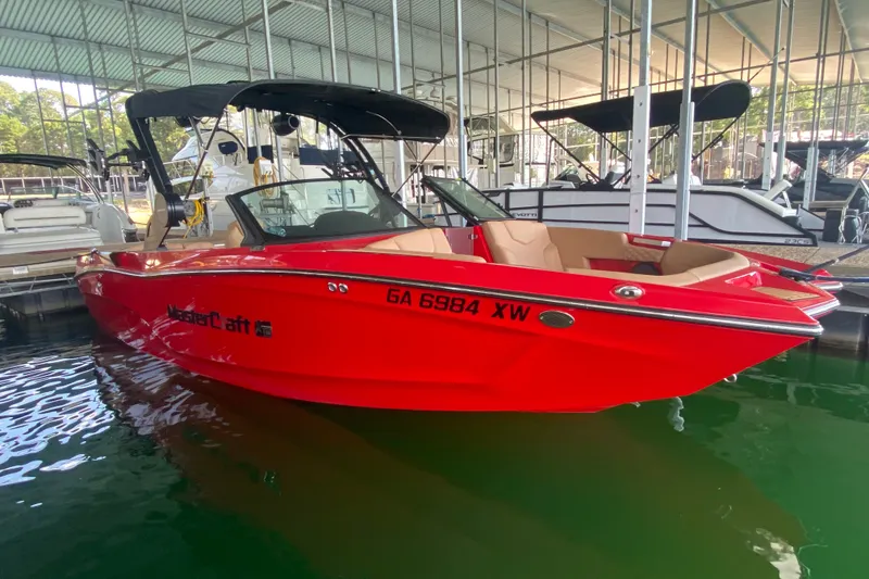 Slide: The Image of 2024 MasterCraft XT22 boat in vibrant red, docked in a marina. - 3