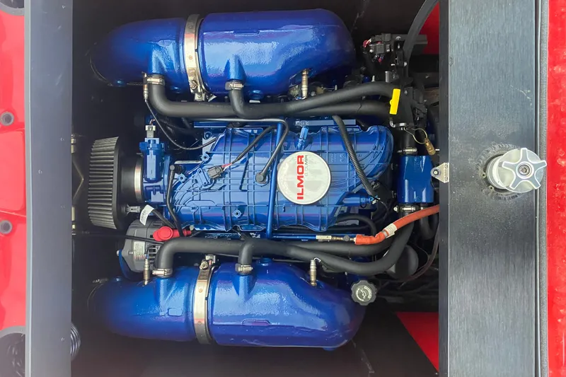 Slide: The Image of 2024 MasterCraft XT22 Ilmor engine, blue with visible components and hoses. - 12