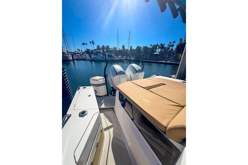 Slide: The Image of 2021 Axopar 37 XC Cross Cabin boat docked in a sunny marina. - 17