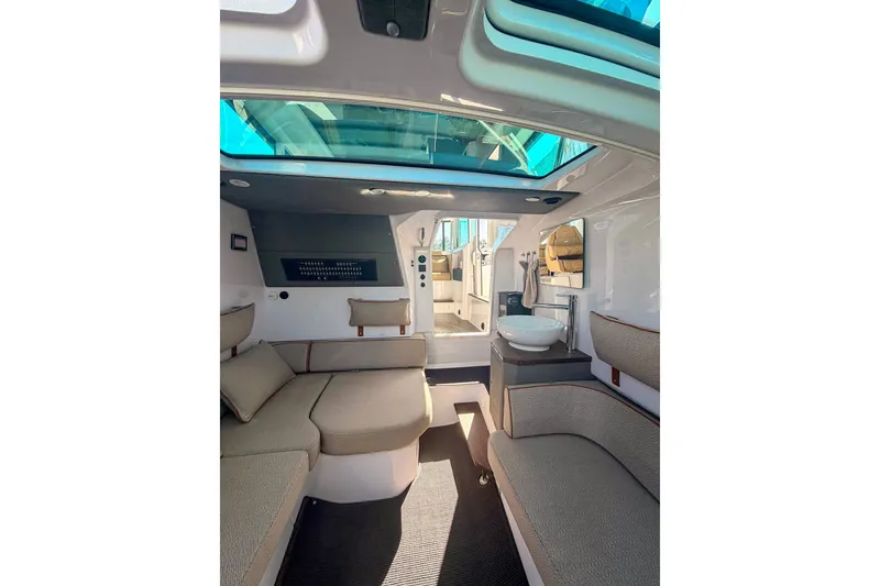 Slide: The Image of Interior of 2021 Axopar 37 XC Cross Cabin with modern seating and skylight. - 27