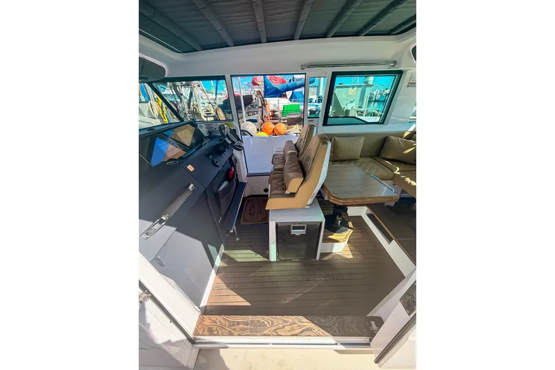 Slide: The Image of Interior of 2021 Axopar 37 XC Cross Cabin with seating and helm station. - 21