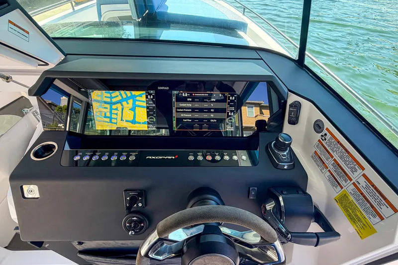Slide: The Image of Cockpit view of 2021 Axopar 37 XC Cross Cabin with navigation display and controls. - 18