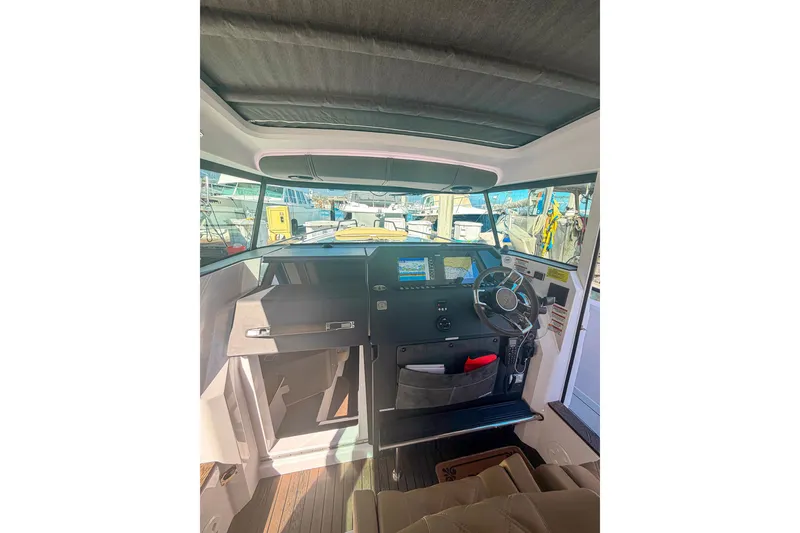 Slide: The Image of Interior view of 2021 Axopar 37 XC Cross Cabin helm with modern navigation equipment. - 20