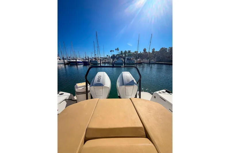 Slide: The Image of 2021 Axopar 37 XC Cross Cabin boat with twin engines in a sunny marina. - 15