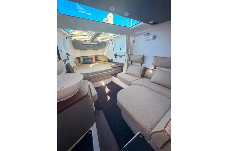 Slide: The Image of Luxurious interior of 2021 Axopar 37 XC Cross Cabin with plush seating and skylight. - 25