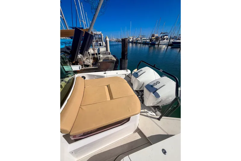 Slide: The Image of 2021 Axopar 37 XC Cross Cabin with twin outboard engines docked at marina. - 16