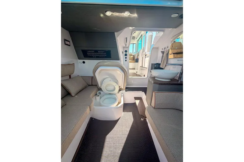 Slide: The Image of Interior of 2021 Axopar 37 XC Cross Cabin with seating and compact toilet. - 28