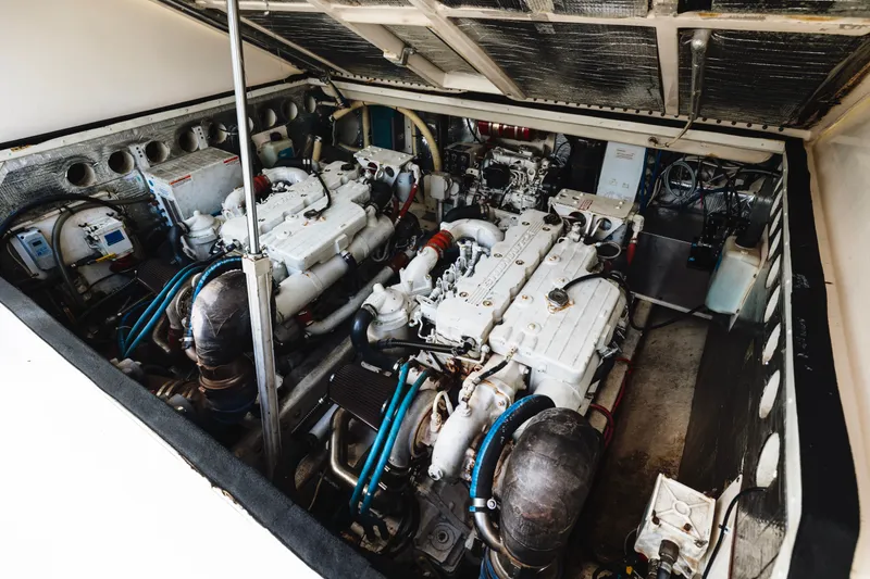 Slide: The Image of Engine compartment of a 2006 Carolina Classic 32 boat, showcasing dual engines. - 38