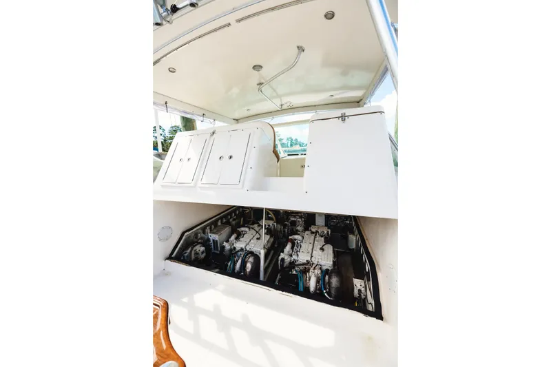 Slide: The Image of 2006 Carolina Classic 32 boat engine compartment with open hatch, showcasing dual engines. - 40